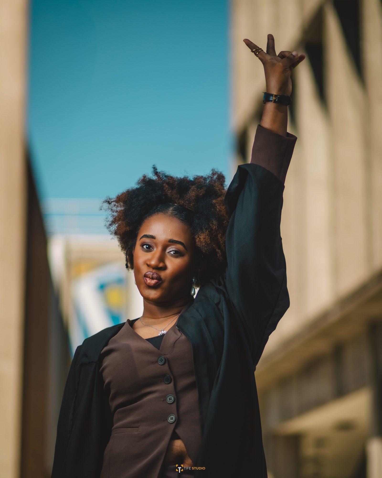 Graduation portrait - hand raised